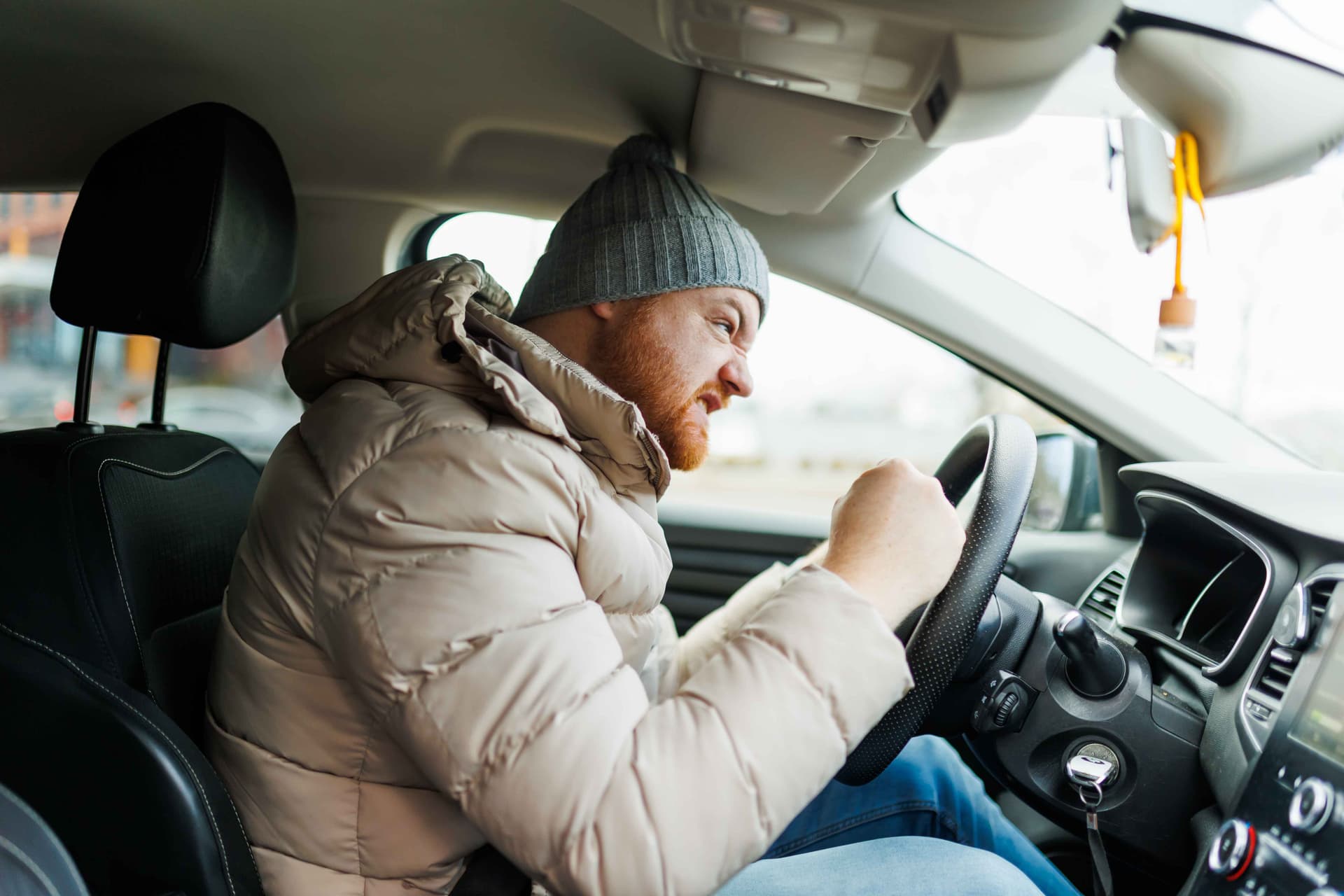 A driver exhibiting aggressive driving behavior in heavy traffic.